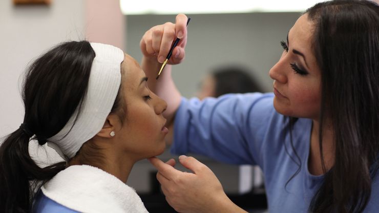 Cosmetology students at the Central California Women’s Facility practice applying makeup during a lesson in 2017.
