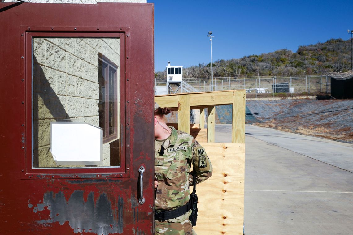 A prison guard outside of Camp 6 at Guantánamo Bay. Under the government's ground rules, no identifiable faces of guards can be shown.