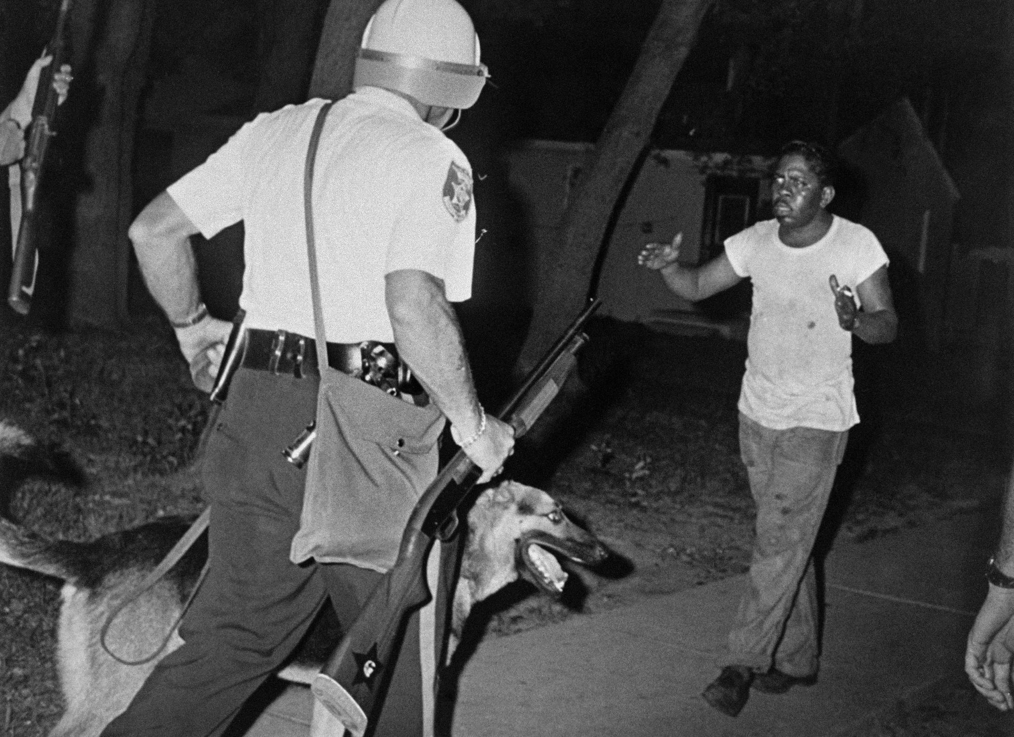 Officers brought dogs to the Newark race riots of 1967, which began in response to the beating by police of John Smith, a Black cab driver. An officer with a dog argued with a man on July 14, 1967. 