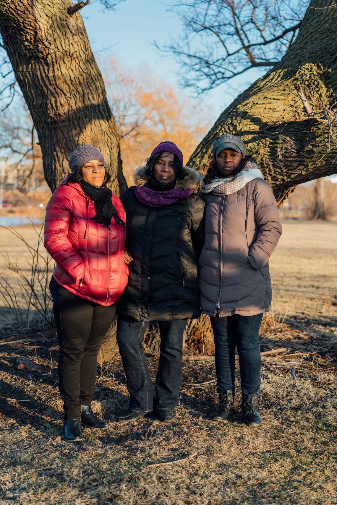 Simmons’ sisters in January. From left, Tiffany Ryan, Debra Simmons, and Renesa Peterson stand at the tree in Washington Park in Chicago where they scattered their parents’ and brother’s ashes. 