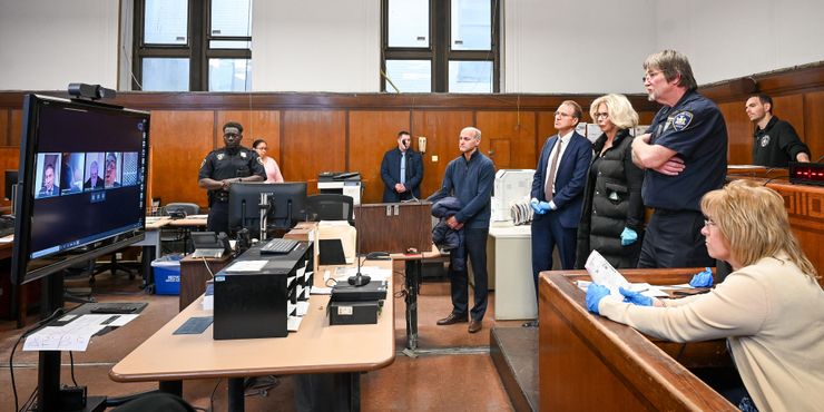 New York State court officials watch a virtual arraignment hearing inside Manhattan criminal court in March. 