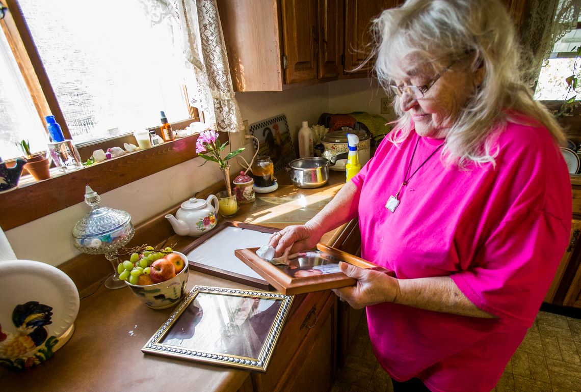 Alma Glisson looks at photos of her son, Nicholas Glisson, who died when at the Plainfield Correctional Facility in Plainfield, Ind.