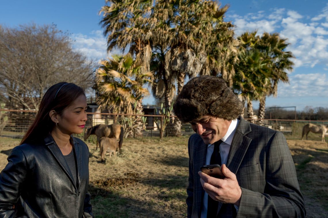 Chattler talking to Lee Harris on the phone, as his wife Maricar Chattler looks on. 