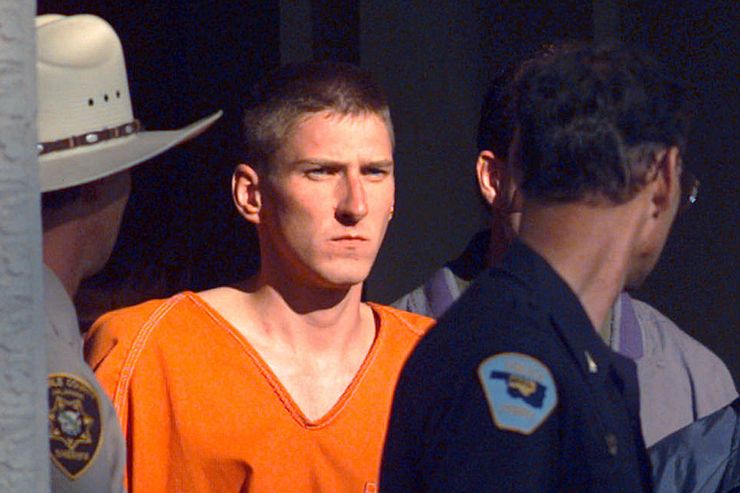 FILE - In this April 21, 1995 file photo, Timothy James McVeigh is lead out of the Noble County Courthouse by state and federal law enforcement officials in Perry, Okla., after being identified as a suspect in the bombing of the Oklahoma City Federal building. McVeigh was sentenced to death and executed. (AP Photo/John Gaps III)