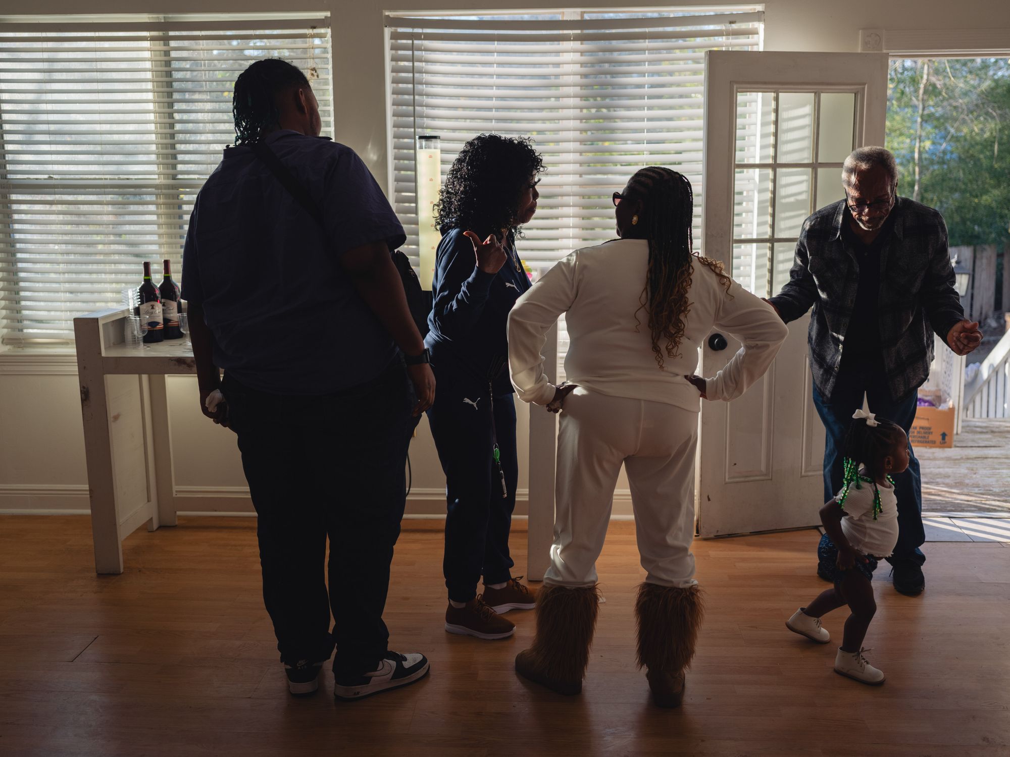 Armour, second from left, stands in a room with her nephew, sister, Moses and her great-niece.