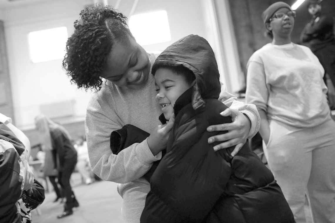 Lakeisha, an inmate at the Logan Correctional Center, hugs her son, Jayden, as he arrives for a visit. More than 100 children and caregivers were brought to see their mothers.