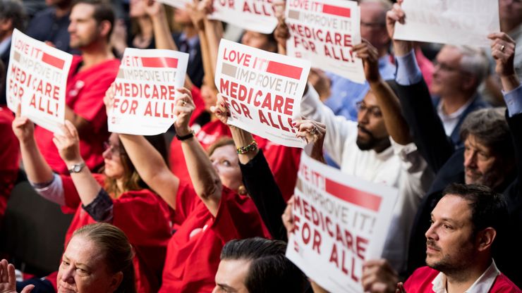 Supporters of Sen. Bernie Sanders, D-Vt., wave signs in support of “Medicare for All” at an event in 2017.