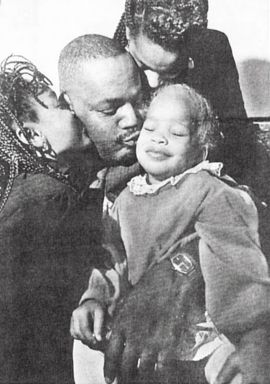 Phillip Chance embraces his family in a snapshot from the mid-1990s. 