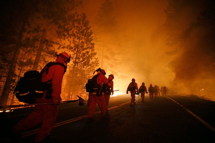 An inmate fire crew walk along Highway 120 as firefighters continue to battle the Rim Fire near Yosemite National Park in California in 2013. 