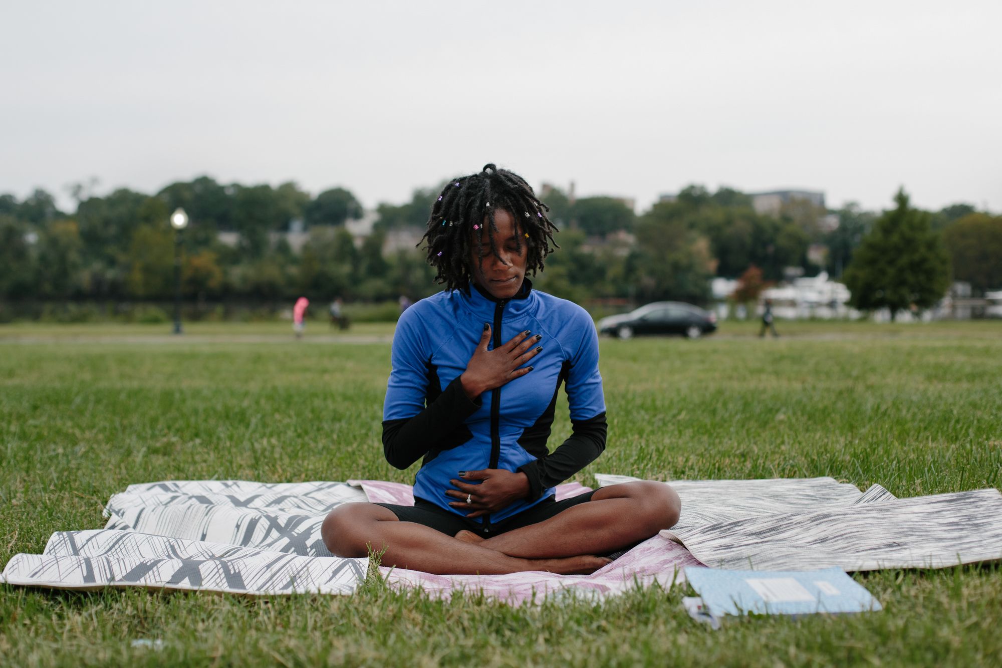 With hands resting on her chest, Chaney inhales during a yoga movement in Anacostia Park the morning of Sept. 24, 2020. Chaney turned to yoga in 2019 as a means to process emotions and heal the trauma of her mother’s incarceration that had manifested over time.