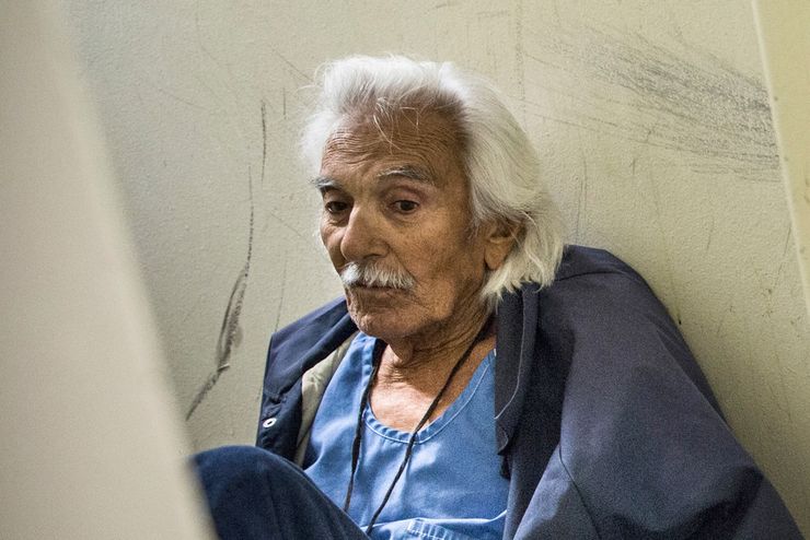 SAN LUIS OBISPO, CA - DECEMBER 19: (Editorial Use Only)  Anthony Alvarez (L), age 82, waits for the daily prisoner count while sitting on the floor of his cell at California Men’s Colony prison on December 19, 2013 in San Luis Obispo, California. Alvarez is helped by the Gold Coats,  a volunteer care program where healthy prisoners volunteer to take care of elderly prisoners who either need general assistance with mobility and every day life or who also struggle with Alzheimer’s and dementia. The program, the first of it’s kind in the country, has existed for approximately 25 years. According to Alvarez, he has been incarcerated for 42 years due to a series of burglaries, possession of illegal firearms and escapes from county jail. Eventually these convictions led to him getting a life sentence due to three-strike laws. “I never shot anyone,” Alvarez said, “I had the chance but I could never shoot anyone.” Today is Alvarez’s first day being assisted by the Gold Coats; he largely needs help with mobility. Alvarez tries to work out for a few minutes every other day. He says he would like to apply for compassionate release, a program where prisoners are released from prison after being found no longer a threat to society, or if a doctor deems that they are within the last six months of their life.  (Photo by Andrew Burton/Getty Images)