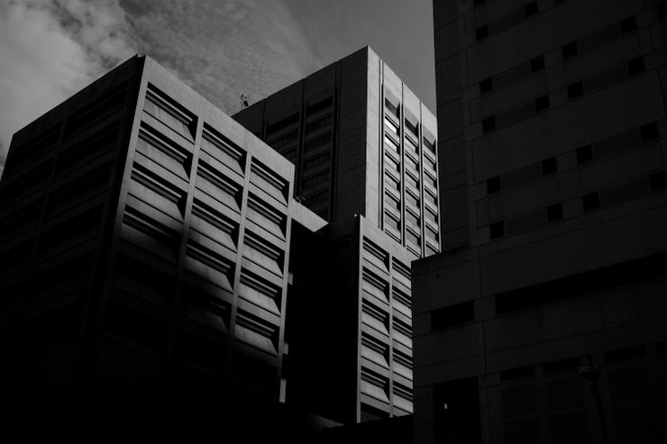 A view of the top of the Cuyahoga County Justice Complex, which includes the county jail.  The building has narrow horizontal windows, and is partly in shadow.