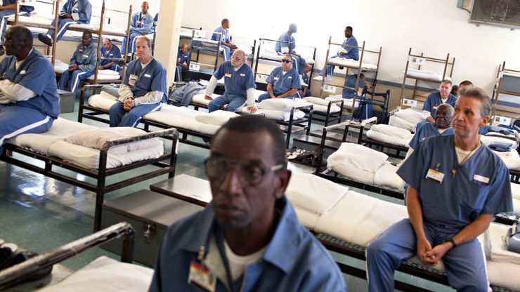 Prisoners wait for a morning head count at the Sumter Correctional Institution in Bushnell, Fla.