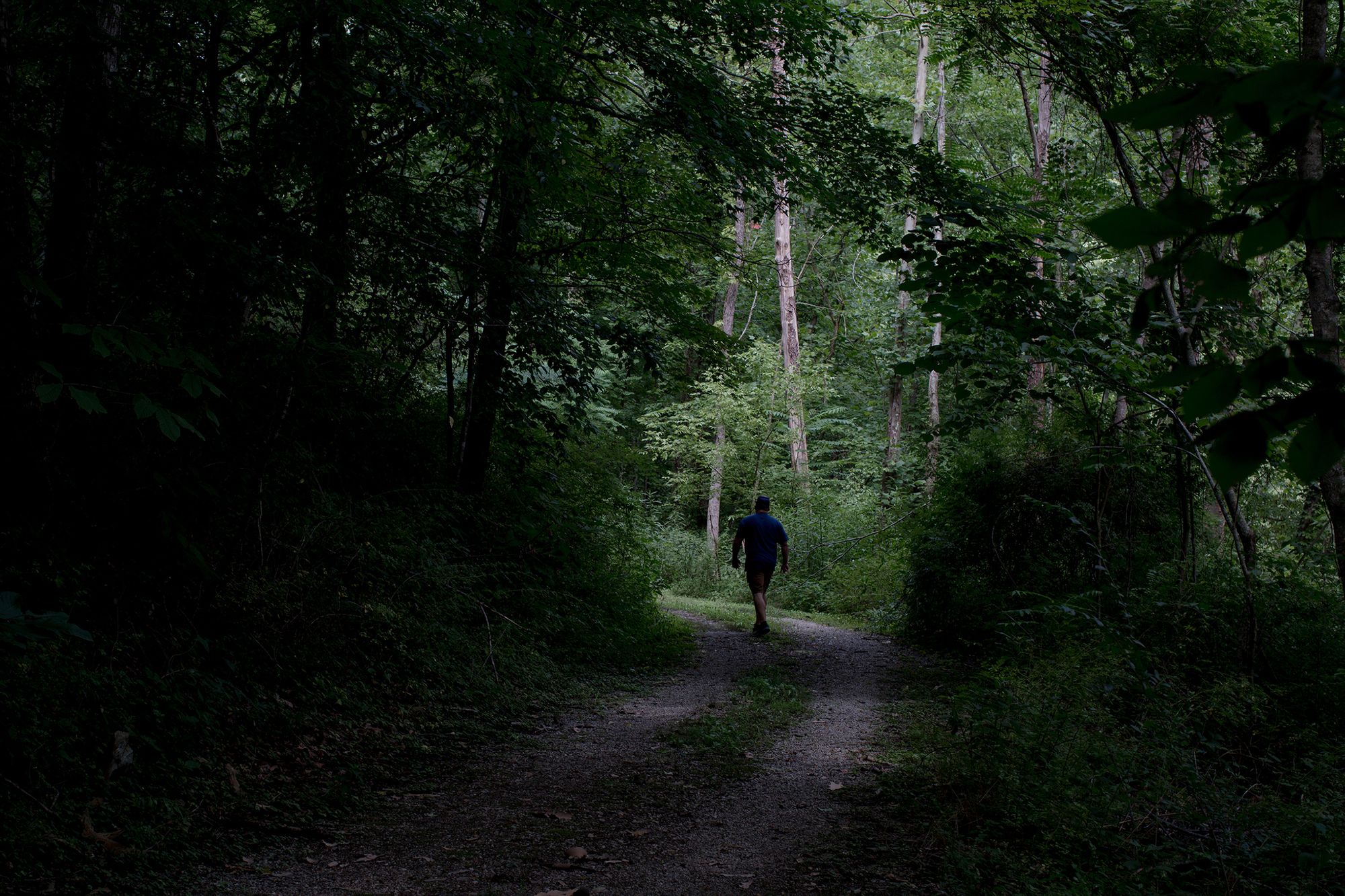 Gary Grant walks near a river where he used to fish with his brother Bradley in Harlan, Ky., in August. In 2018, Bradley Grant died after he was shot by a state police officer.