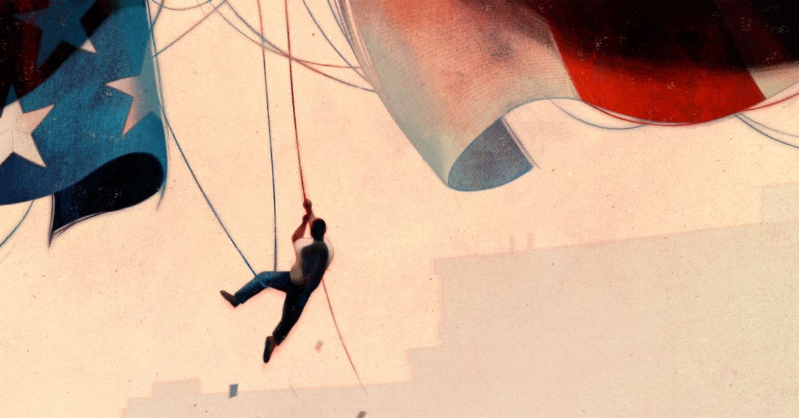 A man wearing blue pants and a white T-shirt dangles from and holds onto the threads of an American flag against a city skyline.