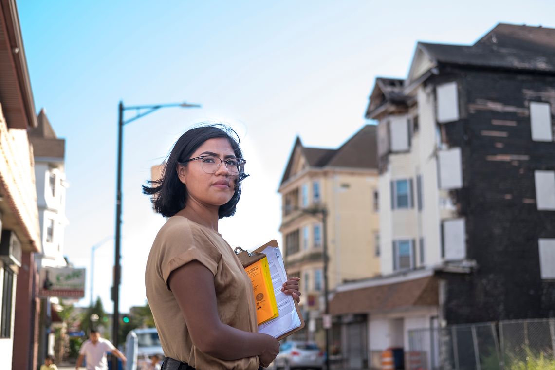 Lucia Mateo Pérez stands in front of her former apartment building in New Bedford in September 2021. Mateo was among the survivors of an April 19, 2021 fire that destroyed two buildings in New Bedford, displacing Mayan immigrants from the highlands of Guatemala who work in the port city’s seafood packing plants. 