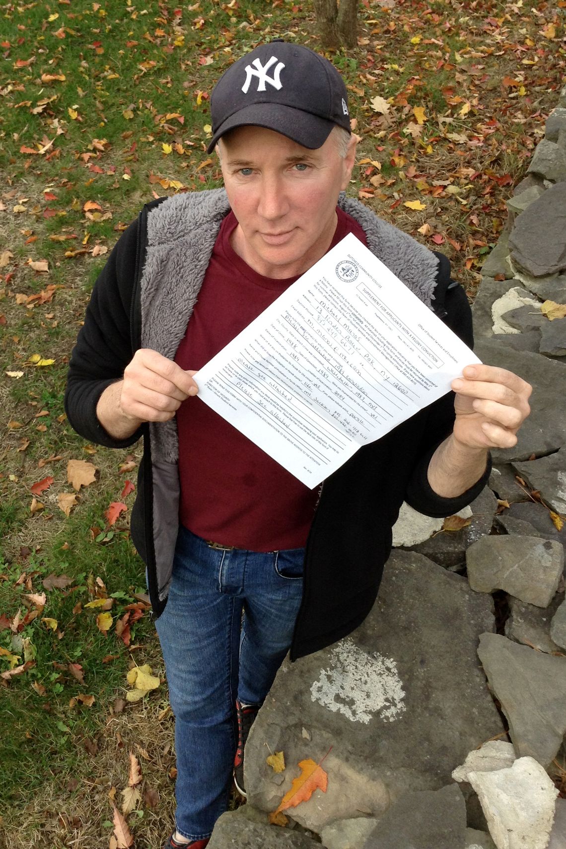 Michael Manos, an ex-felon and first-semester student at Dutchess County Community College, with paperwork given to applicants with a criminal history.