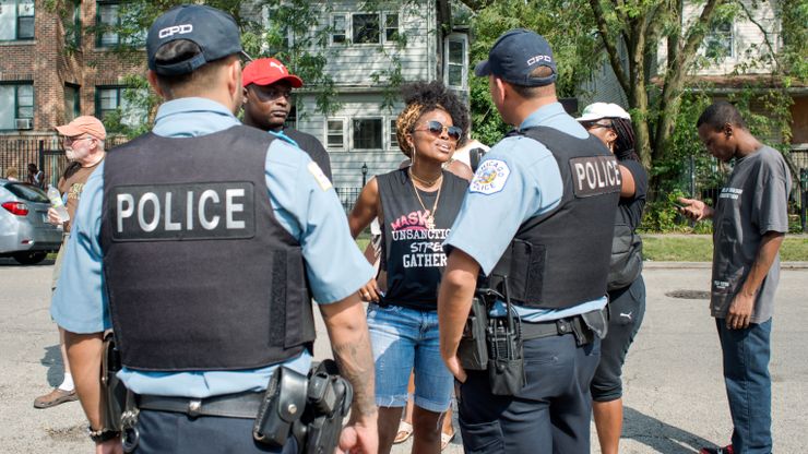 Tamar Massaneh, center, at a Mothers Against Senseless Killings event with police officers in Chicago in August.