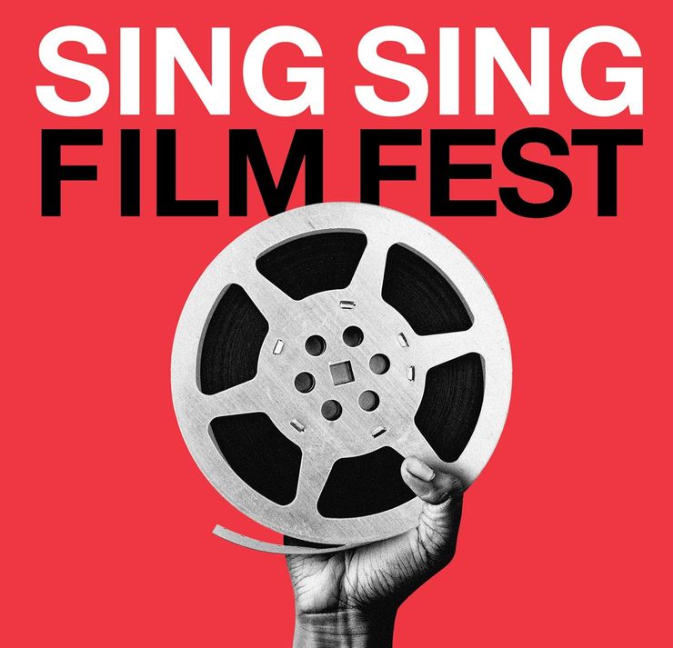 A film festival poster reads: "Sing Sing Film Fest," in large letters at the top. The background of the poster is red, and there is a black and white image of a hand holding up a film reel in the center.