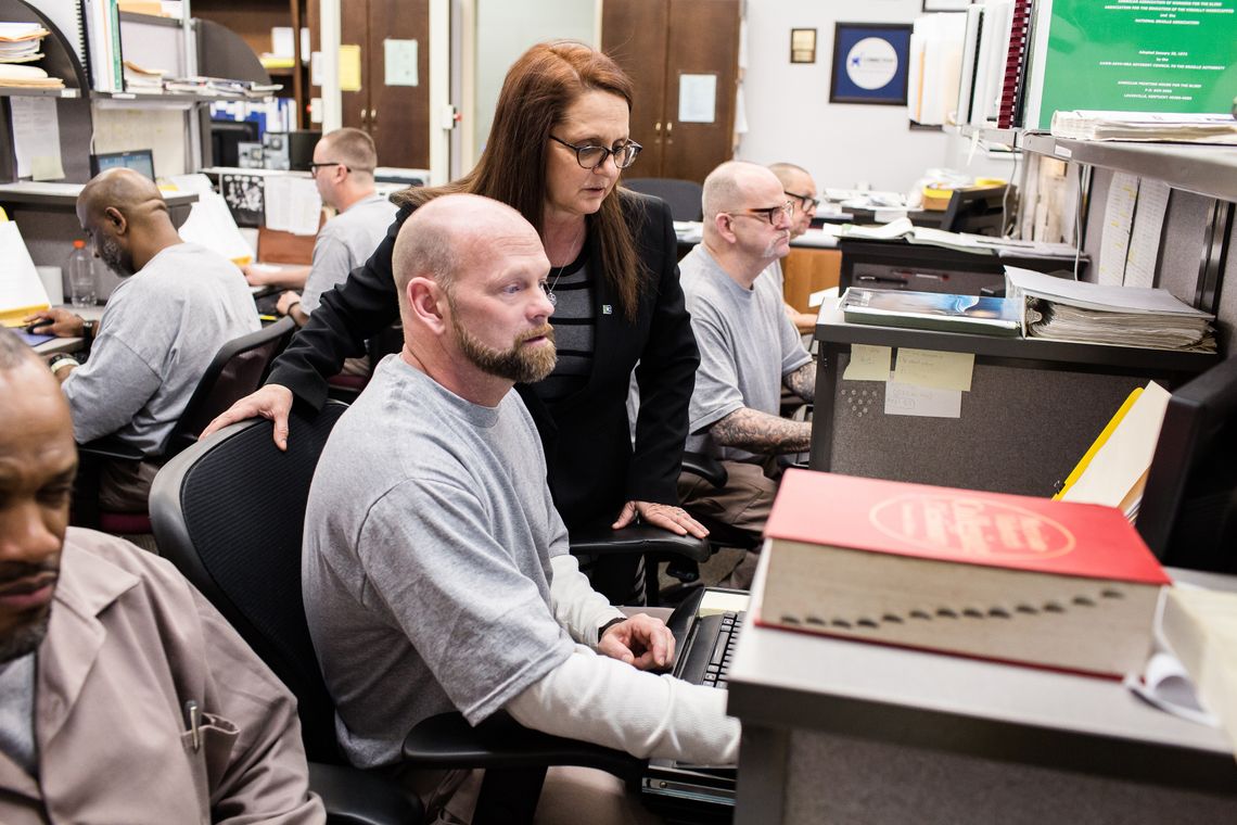 Cynthia Stubbs, a Braille transcription services plant manager, helps Daniel Beverly as he transcribes a textbook to Braille at Scotland Correctional Institution in Laurinburg, N.C. 