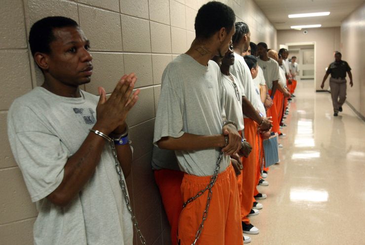 Men wait for an afternoon court appearance at the Milwaukee County Jail in 2009.