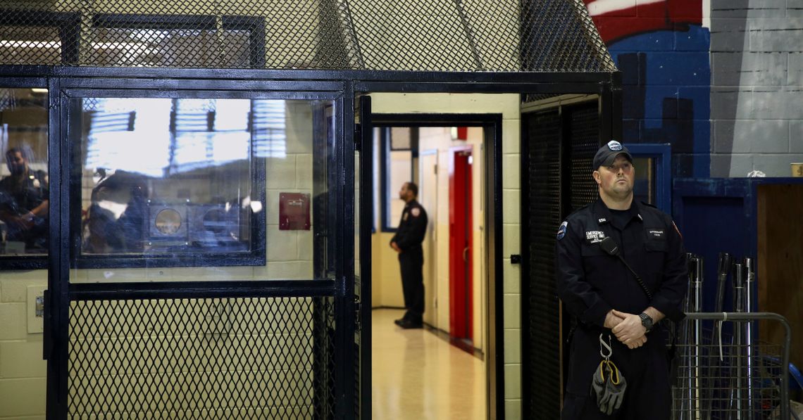 Corrections officers stand guard at a unit at the Rikers Island jail complex in New York, March 12, 2015.