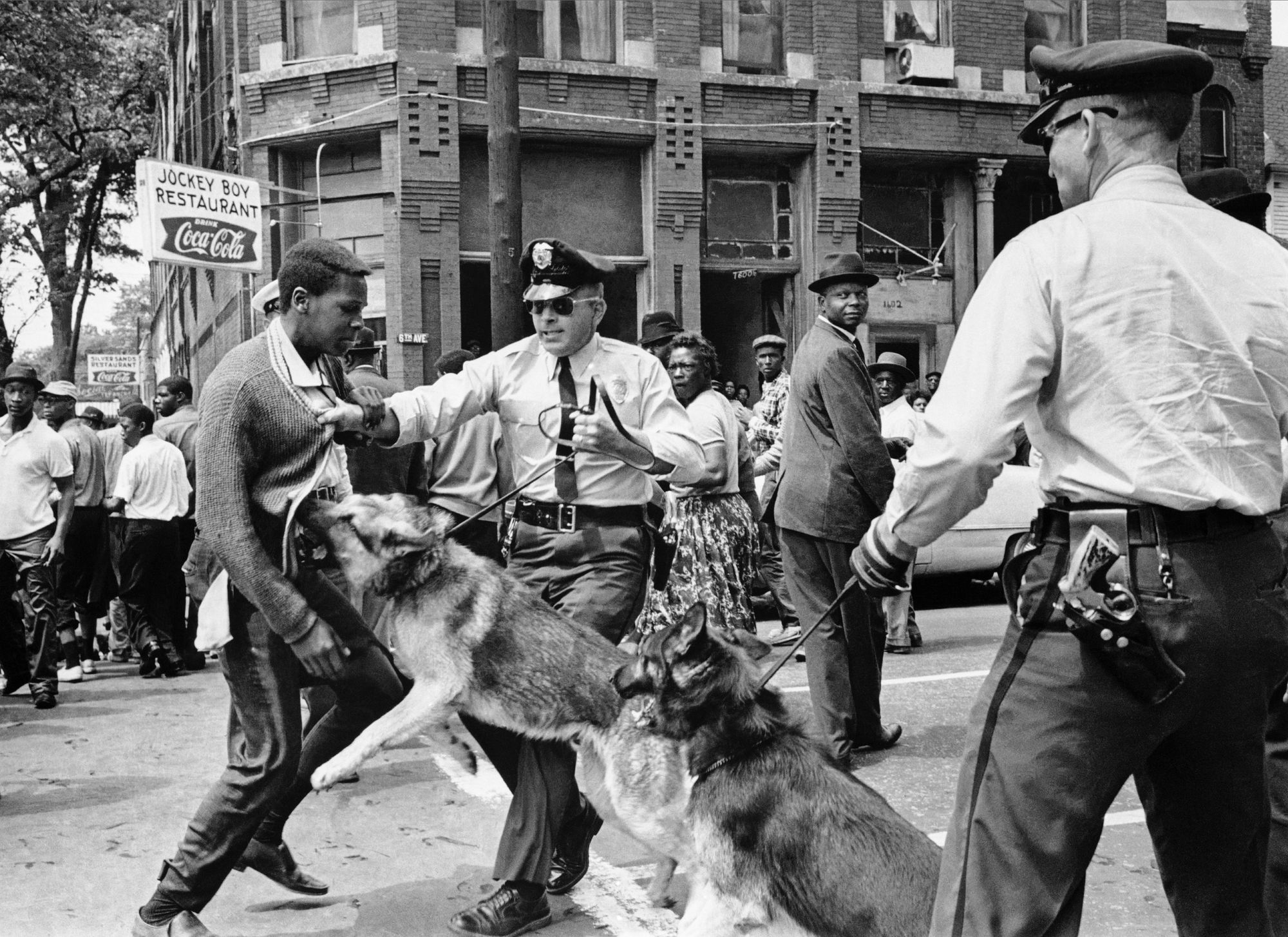 A Black high school student, Walter Gadsden, 15, is attacked by a police dog during a civil rights demonstration in Birmingham, Alabama, in 1963, in this photo by Bill Hudson. These and other iconic images from the Birmingham protests shocked many Americans and helped bring an end to segregation laws.