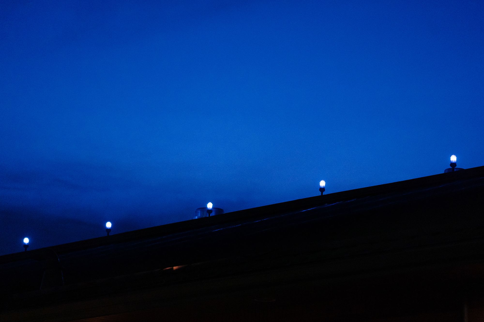 Five small lights are visible on top of the Stoughton Police Department building.