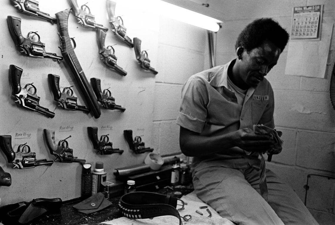 Cleaning pistols at the Cummins Prison Farm, 1975. 