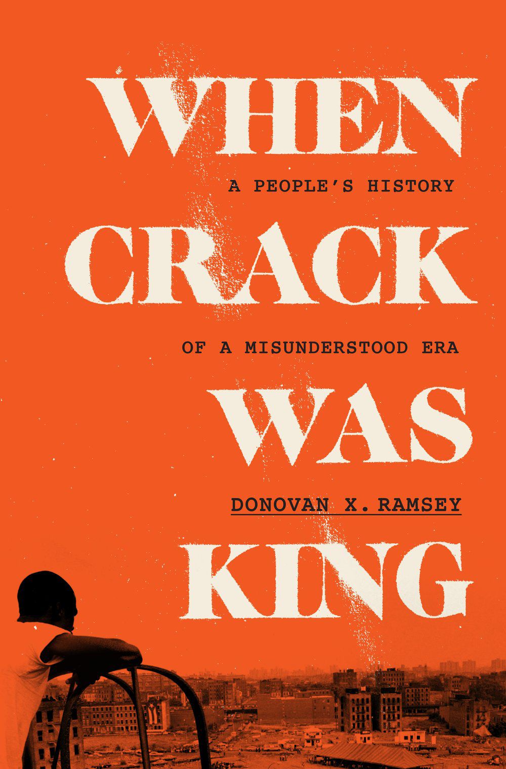 An orange book cover reads, "When Crack was King," Donovan X. Ramsey. At the bottom of the cover is a photo of a Black boy looking out over a cityscape. 