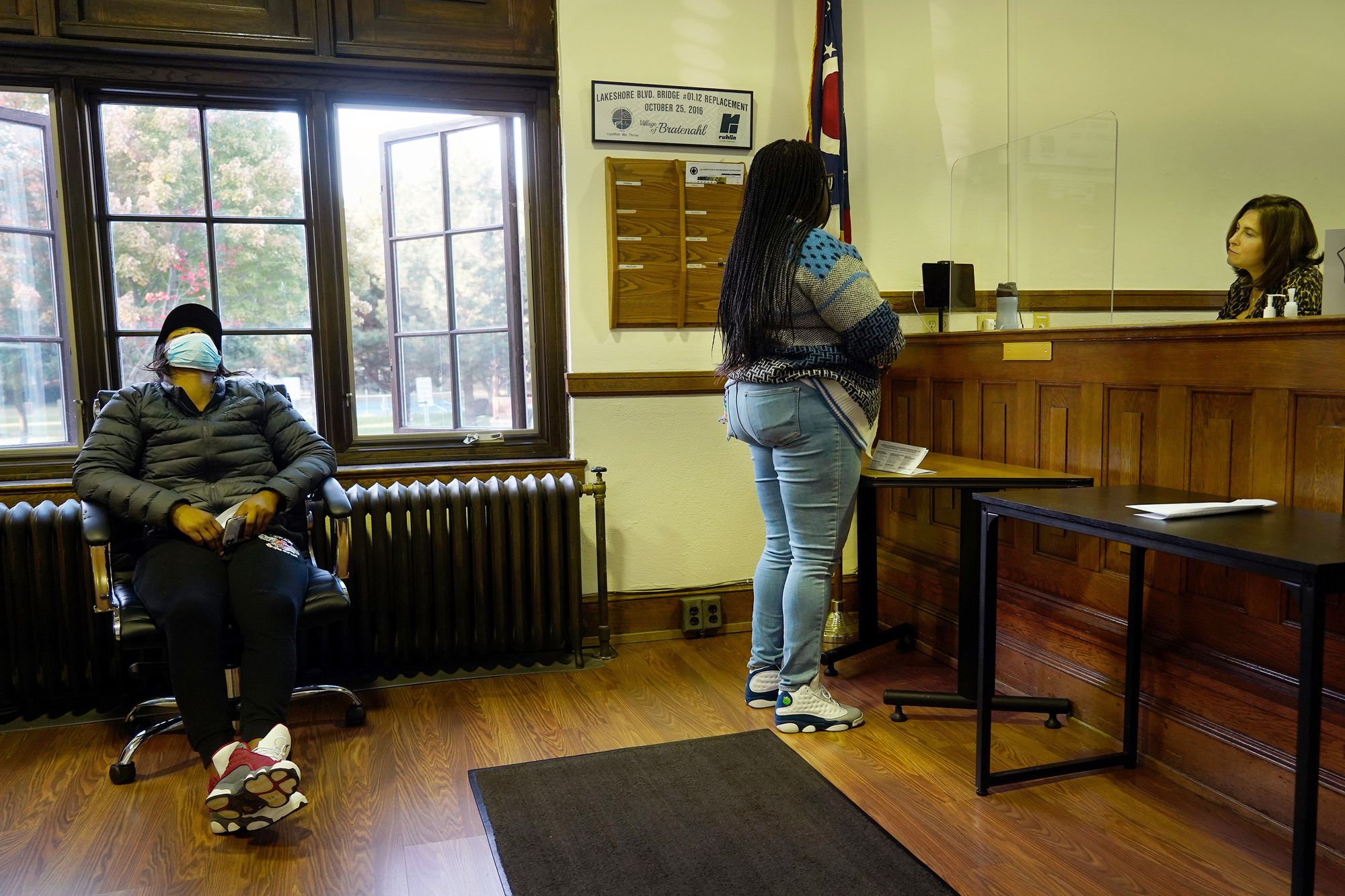 A Black woman stands in front of a desk where Magistrate Andrea Rocco sits. Another woman sits in a chair to the left. 