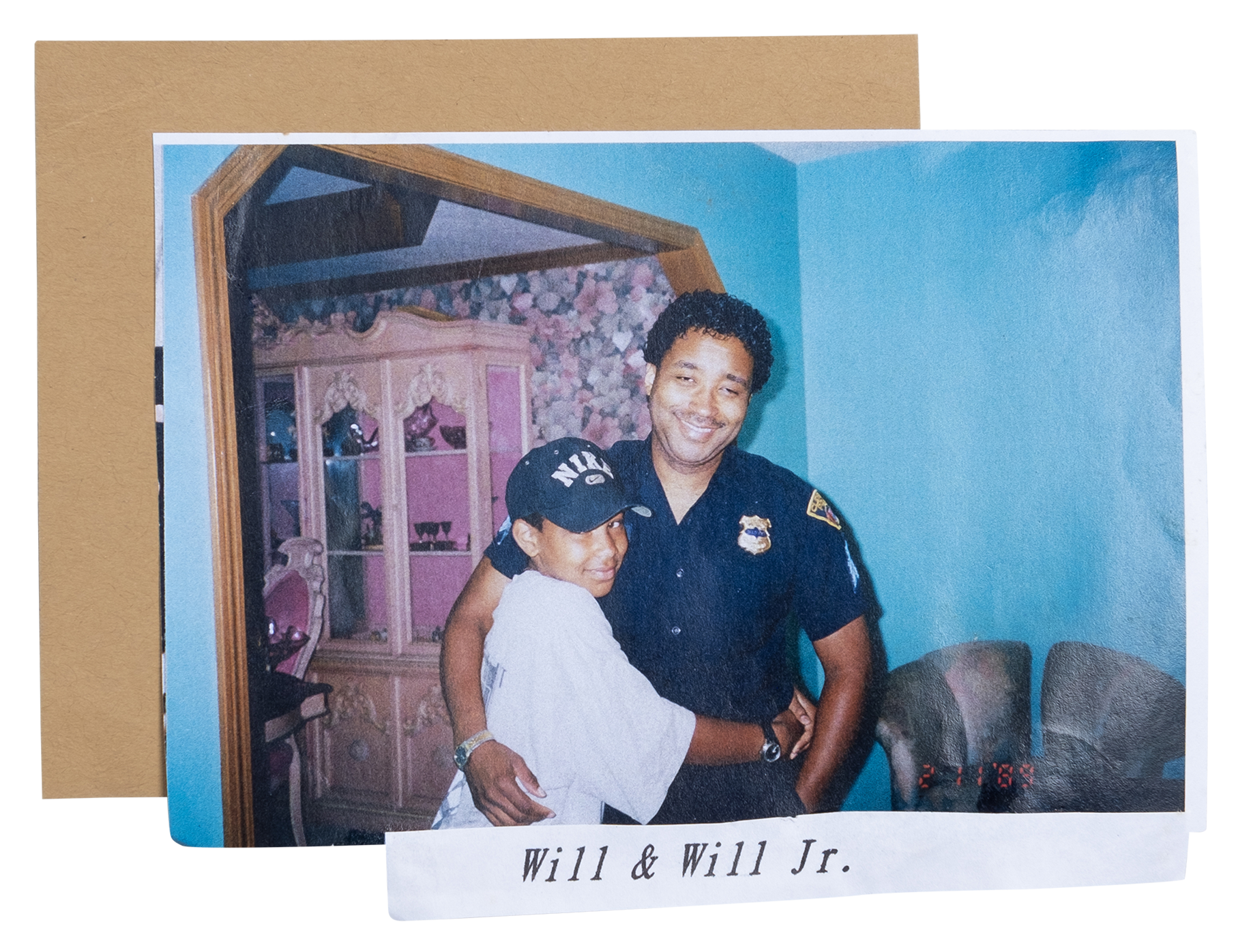 Wilbert Cooper as a child hugging his father, a Black man who is wearing a police uniform.