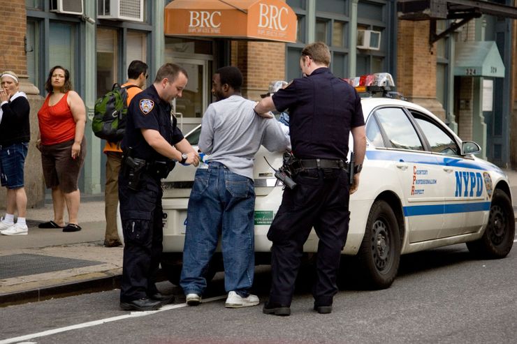 Police officers stop and frisk a man in New York in 2009.