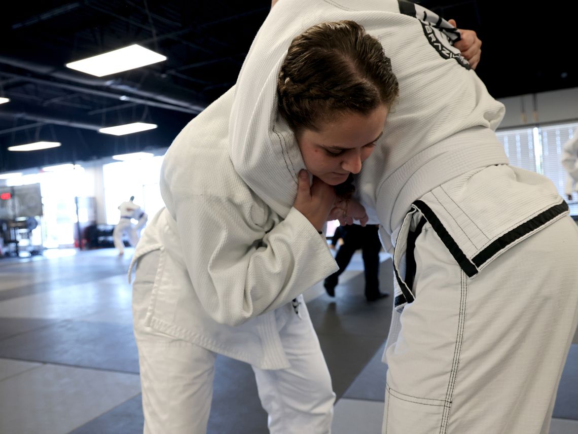 Officer Stacy Fowler of the Marietta Police Department, near Atlanta, spars at the Borges Brazilian Jiu Jitsu gym in Marietta, Ga., on Tuesday, October 19, 2021. The department mandates twice-weekly training sessions.