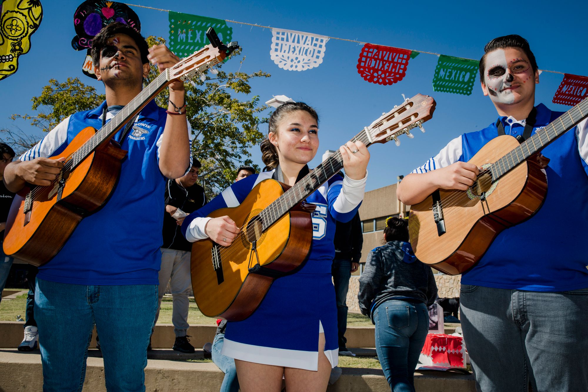 At Bowie, American and Mexican culture blend into one. Here, cheerleader Alexa Scott plays with the school mariachi band during festivities for Dia de los Muertos.