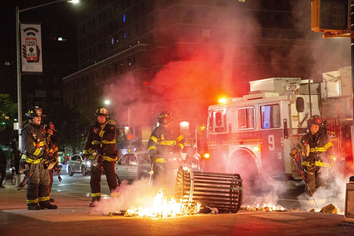 Firefighters put out a trash fire in Greenwich Village during protests on Sunday evening. 
