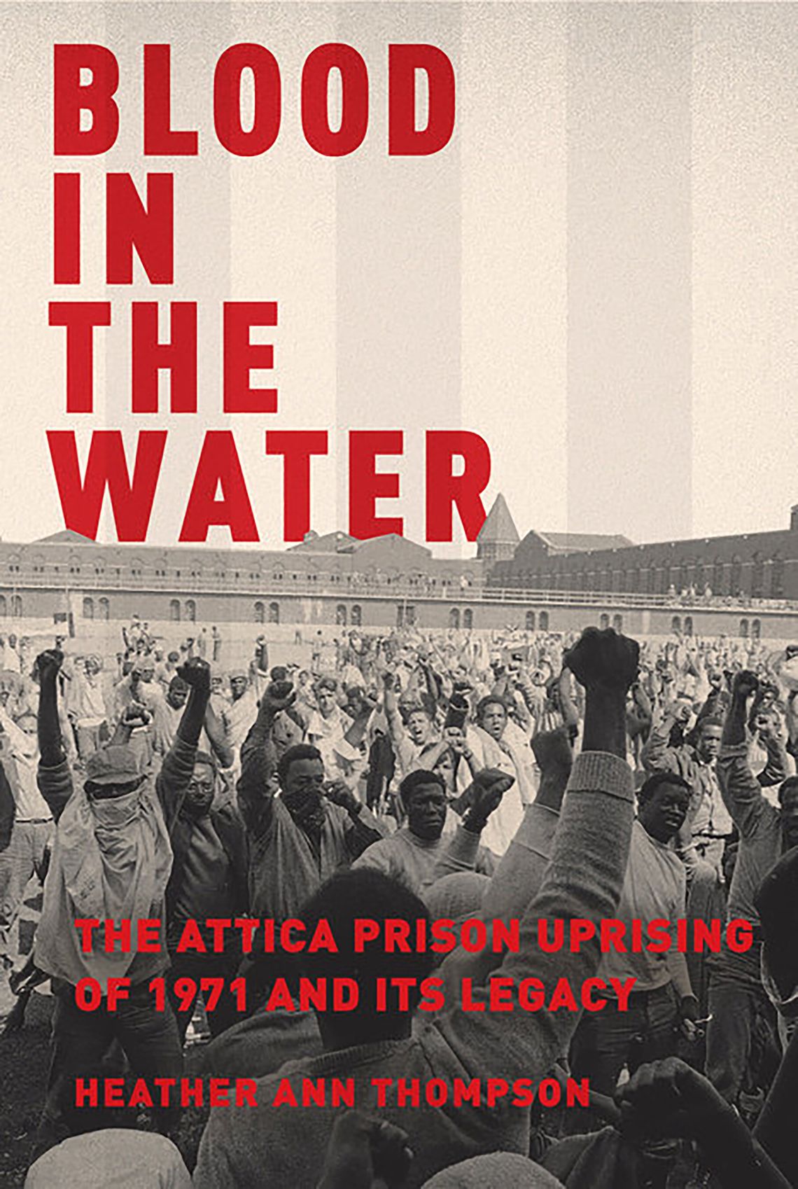 The cover of “Blood in the Water: The Attica Uprising of 1971 and Its Legacy” by Heather Ann Thompson shows a crowd of mostly Black incarcerated people with their fists in the air.