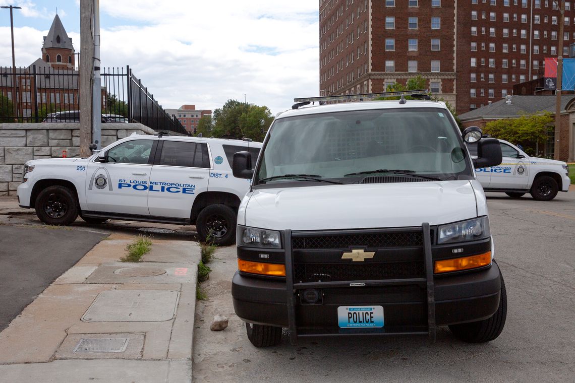 Three police vehicles are parked facing different directions.