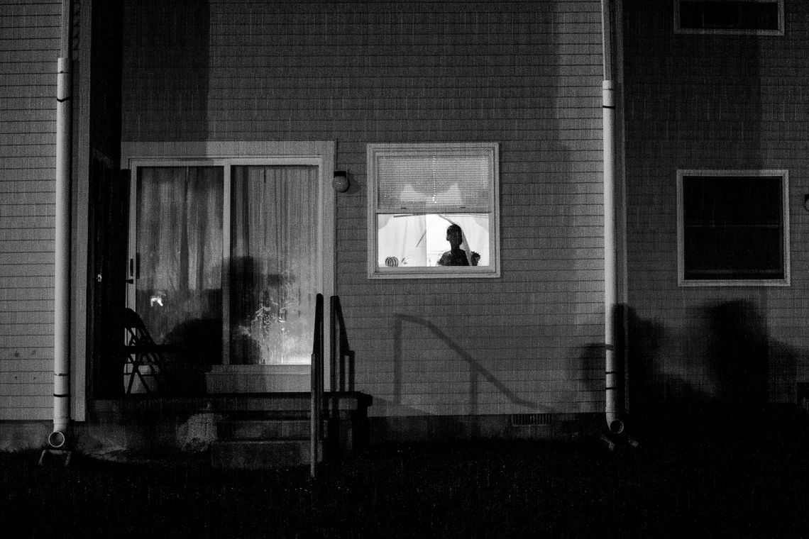 A young girl looks out of a window of her home in the Back Maryland neighborhood of Atlantic City on July 14, 2012. 
