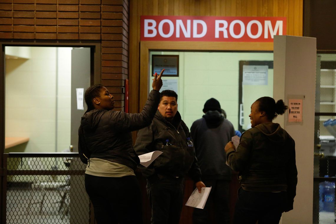 People wait in line to make bond payments at Cook County Jail. 