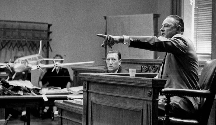 In this image, taken in 1956, a witness points from a courtroom stand in Denver to identify a defendant.