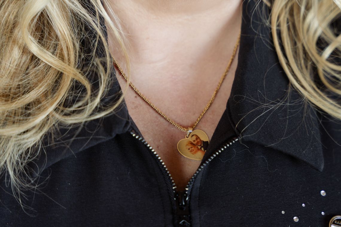 A photo shows a closeup of Sandra’s necklace, which is heart shaped and contains a picture of her with Latif. 