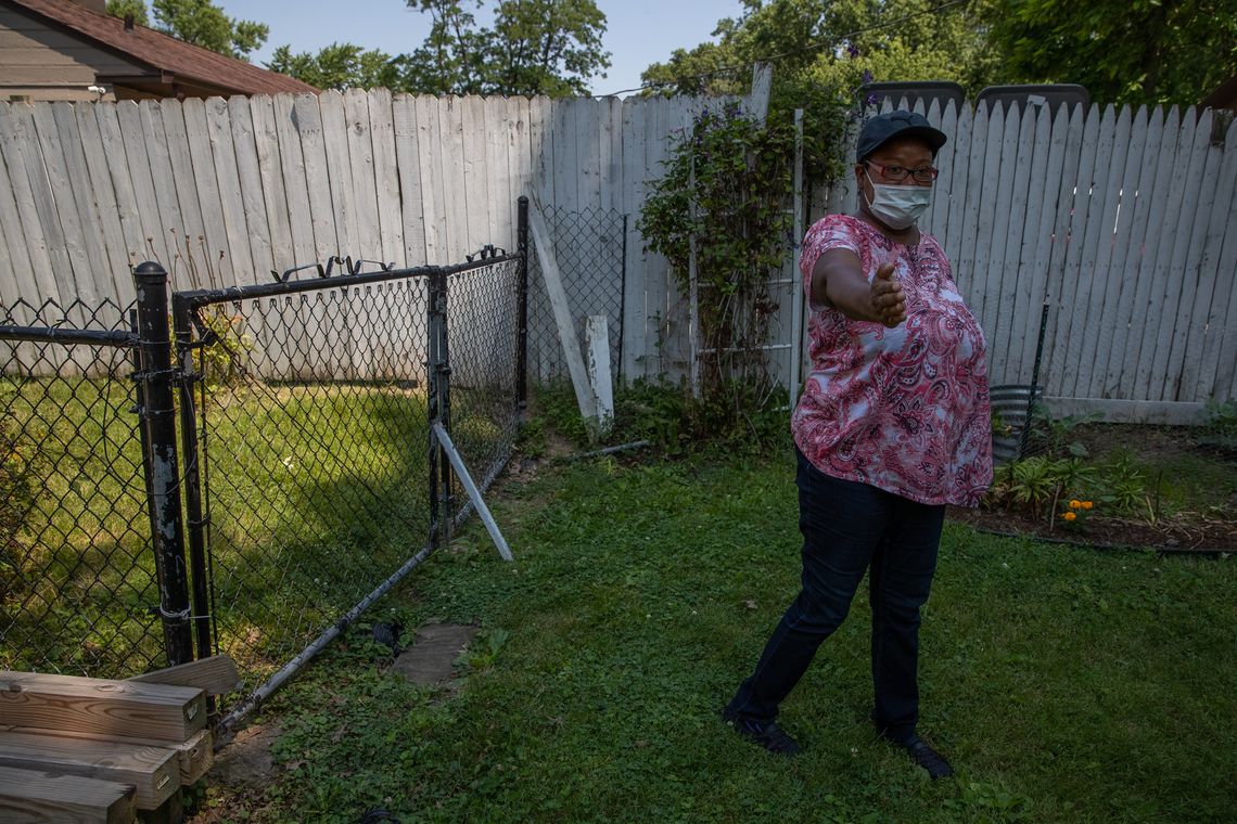 Ella White, daughter of Gordon Mitchum, points out the path an IMPD K-9 officer walked outside Mitchum's home when searching for a suspect in a carjacking that ended on Mitchum's street, on July 6, 2020. "This is the way he always keeps the fence, so they had to have jumped over the fence," she said. White then described using bleach and water to clean up the blood left on her father's patio.