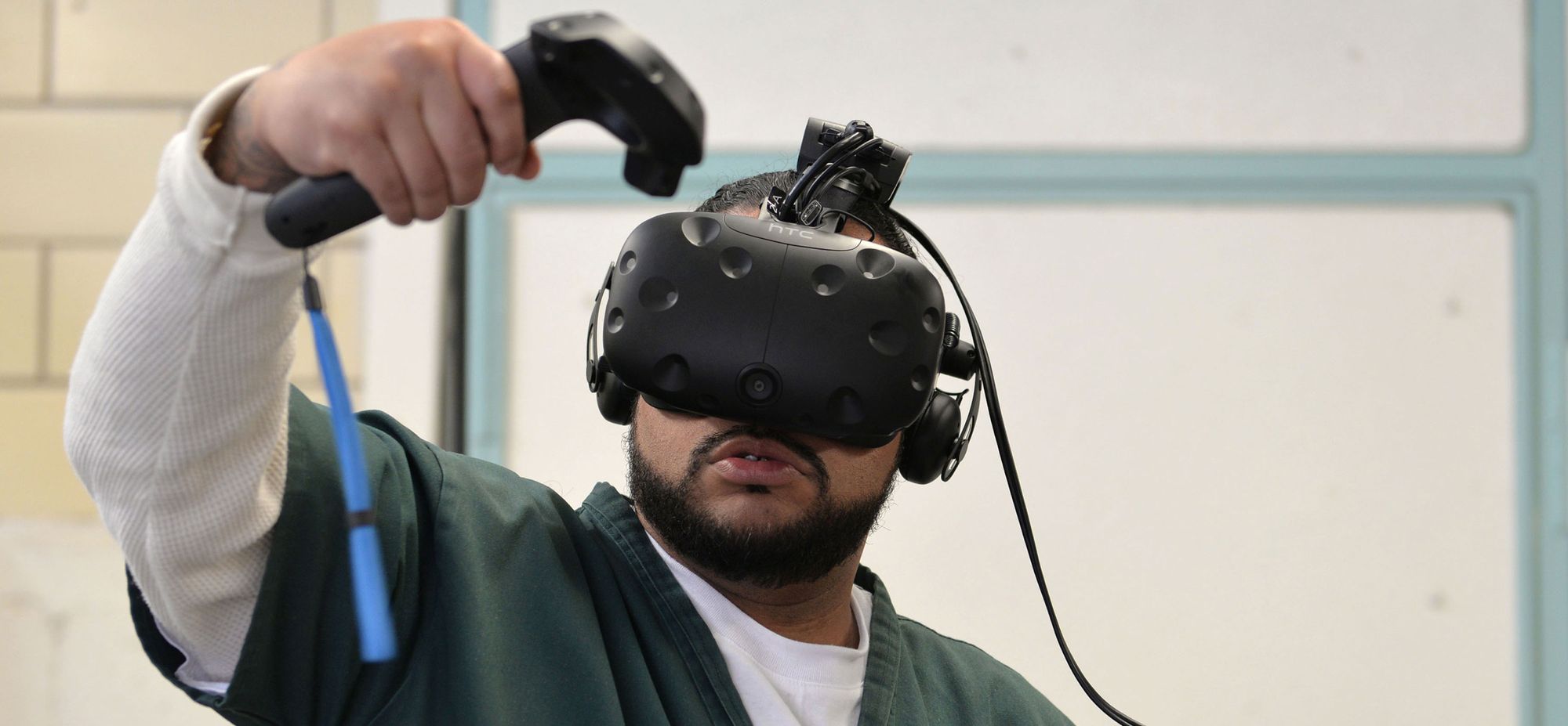 Leroy Gardenhire uses a virtual reality headset at the Fremont Correctional Facility in Cañon City, Colo., to simulate doing laundry at a laundromat.