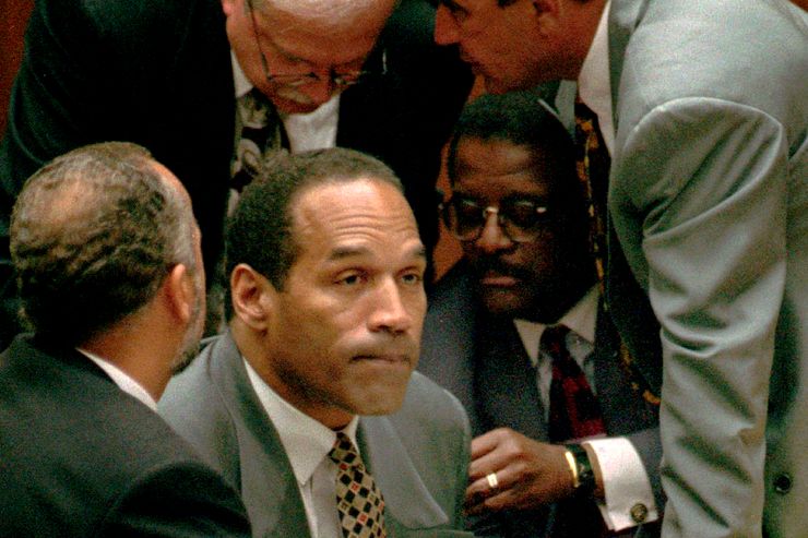 FILE - In this Aug. 29, 1995, file photo, O.J. Simpson, second from left, is surrounded by his attorneys, clockwise from left, Ken Spaulding, back towards camera, Gerald Uelmen, Robert Shapiro and Johnnie Cochran Jr., as they discuss their plans for arguing the admissibility of the tapes of retired Los Angeles police detective Mark Fuhrman in Los Angeles. A lawyer for O.J. Simpson in Las Vegas says the imprisoned former football star isn...t happy with portrayals he...s seen in ads and interviews about a cable TV series focusing on his 1995 murder acquittal in Los Angeles. Simpson won...t be able to see the show, “The People v. O.J. Simpson,” as Nevada prisons don...t carry the FX network, which debuts the 10-part show on Tuesday, Feb. 2, 2016. (Myung J. Chun/Los Angeles Daily News via AP, Pool, File)