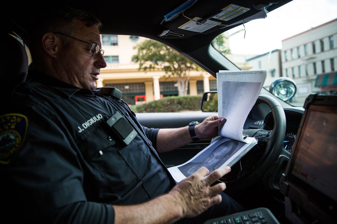 DiGiulio looks at photos of people whom he needs to bring back to court in Stockton.