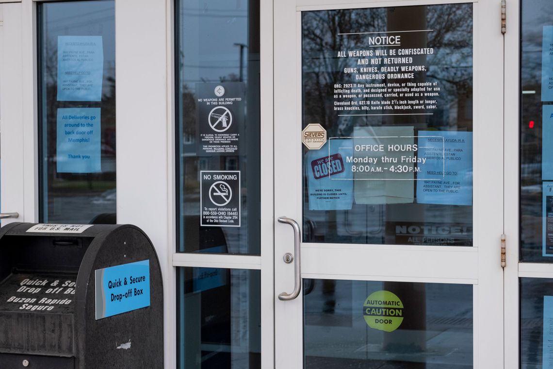 Signs posted outside the door of the Cuyahoga County Office of Reentry. 