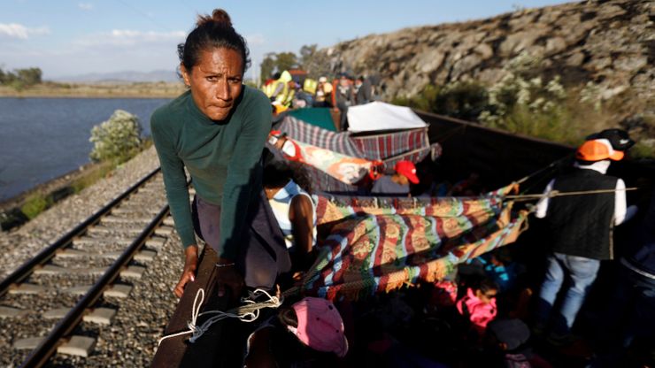 Natalia, 22, a migrant from Honduras, travels on an open wagon of a freight train in Hidalgo state, Mexico, in April. 