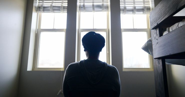 A woman, who left her home because of intimate partner violence, stares outside a window at The Dream Center, a residential recovery facility, in Jackson, Tennessee, in 2023.