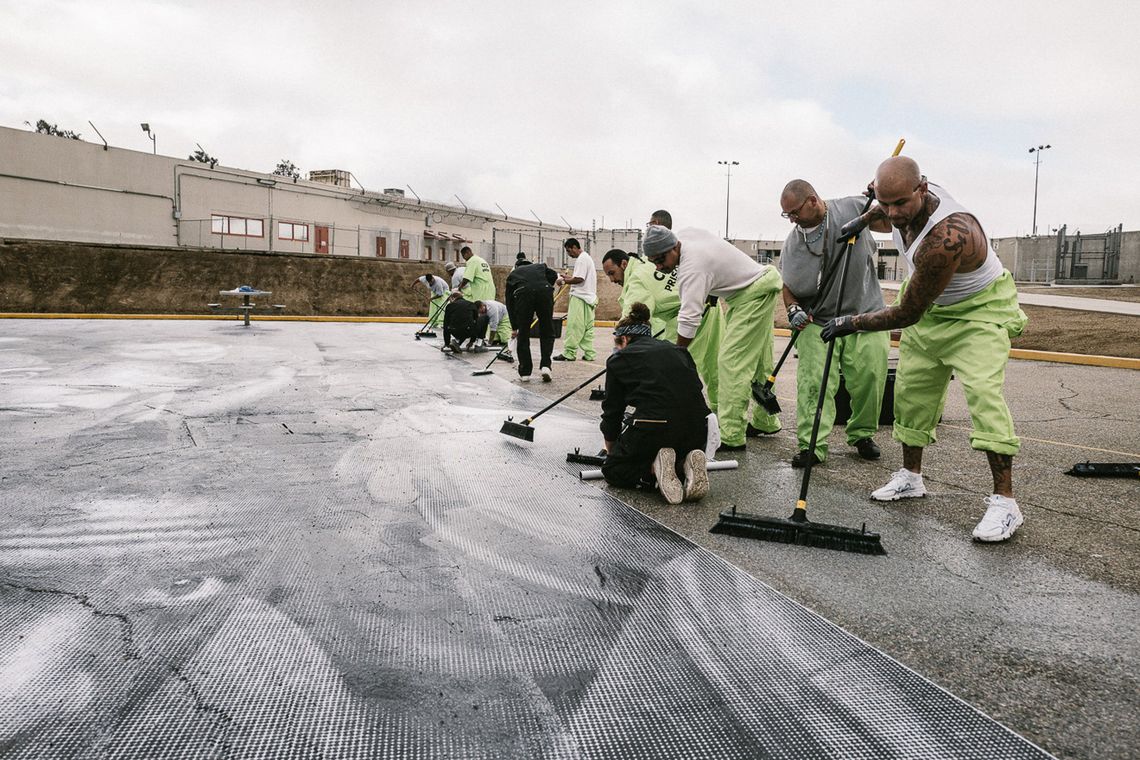 The team worked together to paste 338 paper strips to the ground, using brushes and glue.
